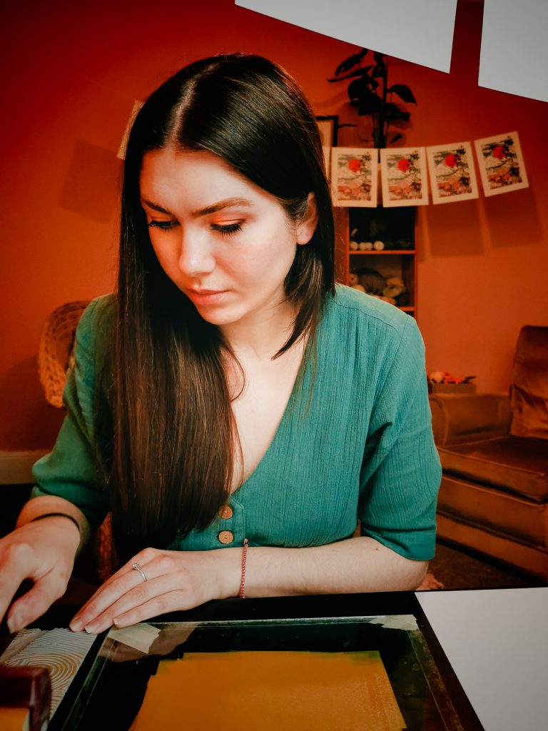 Colour portrait of an artist rolling ink. Taken remotely